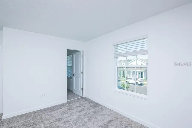 a bathroom with a granite countertop sink a toilet and bathtub