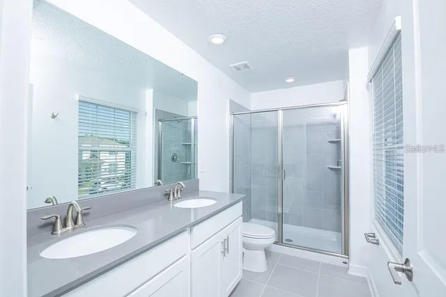 a white toilet sitting next to a bath tub