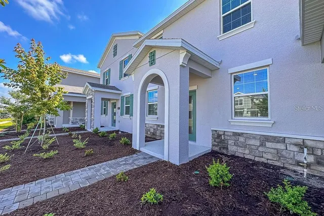 a front view of a house with garden