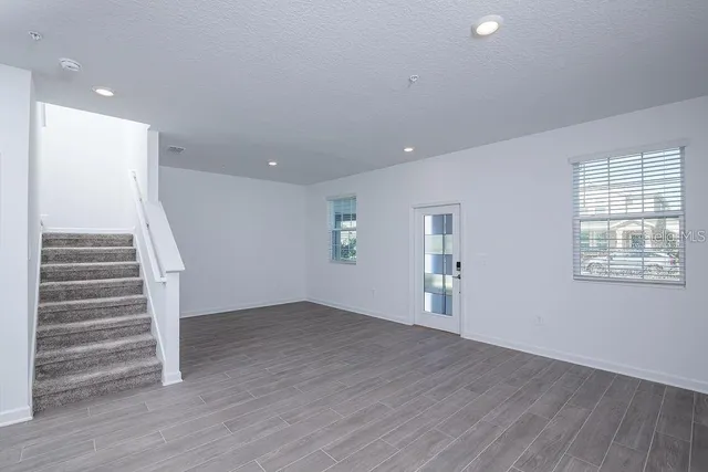 a kitchen with stainless steel appliances a refrigerator sink and white cabinets