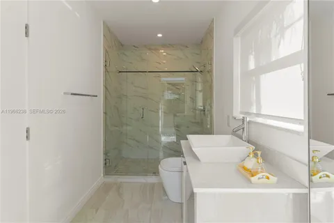 a large kitchen with a table and chairs