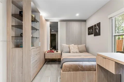 a bedroom with a bed and a chair