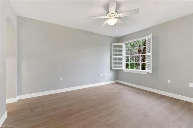 wooden floor in an empty room with a window