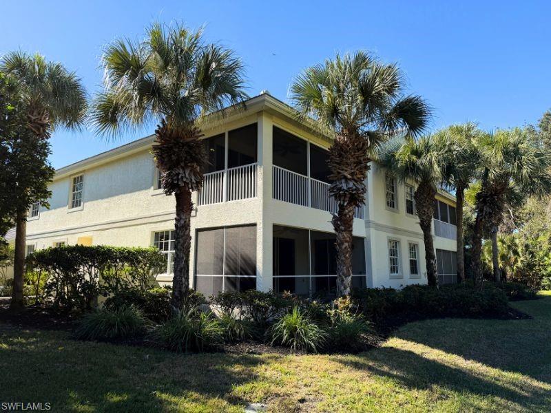 4995 Marsh Turtle Trail, Unit 102 Estero, FL 33928 - Photo 26 of 42 a front view of a house with a garden