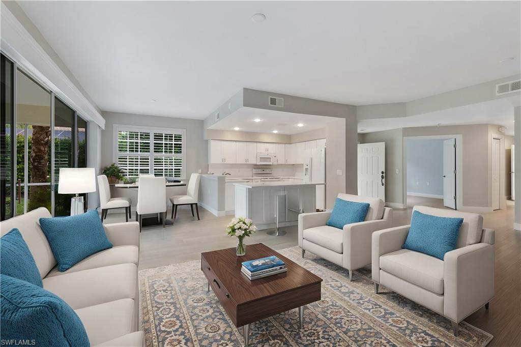 4995 Marsh Turtle Trail, Unit 102 Estero, FL 33928 - Photo 7 of 42 a living room with furniture and a large window