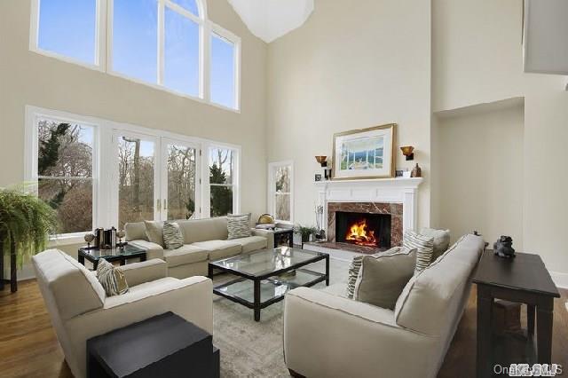 42 South Country Road Westhampton, NY 11977 - Photo 1 of 1 a living room with furniture and a fireplace