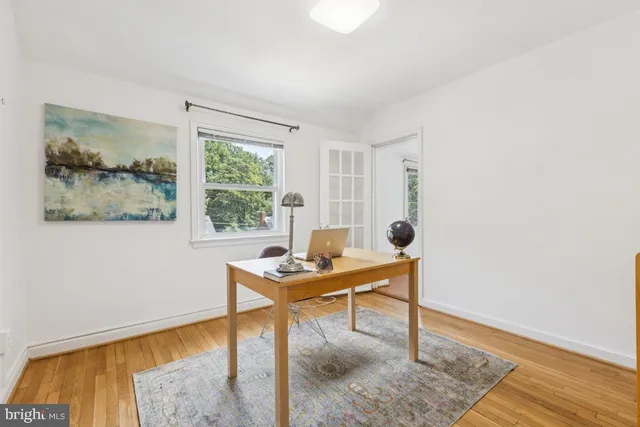 a workspace with wooden floor and a window