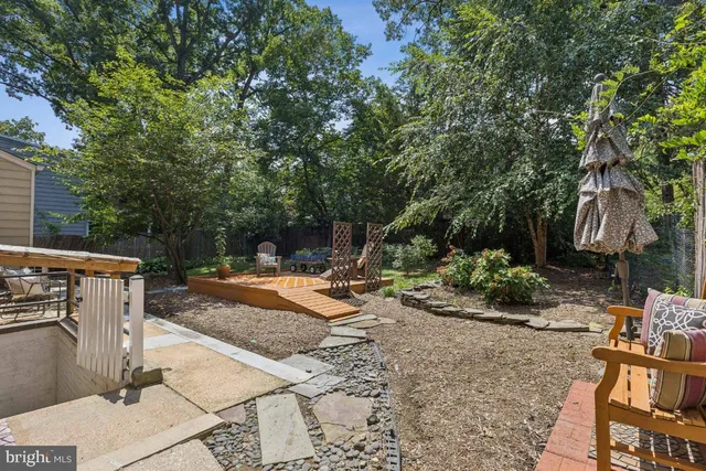 a view of a backyard with plants and a patio