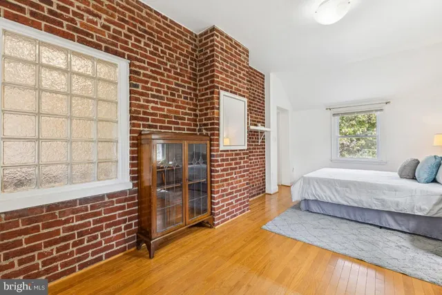 a spacious bedroom with a bed and a window