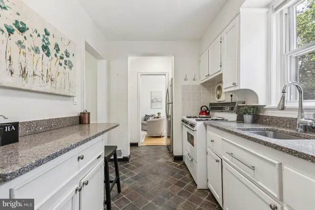 a kitchen with a sink stove and cabinets