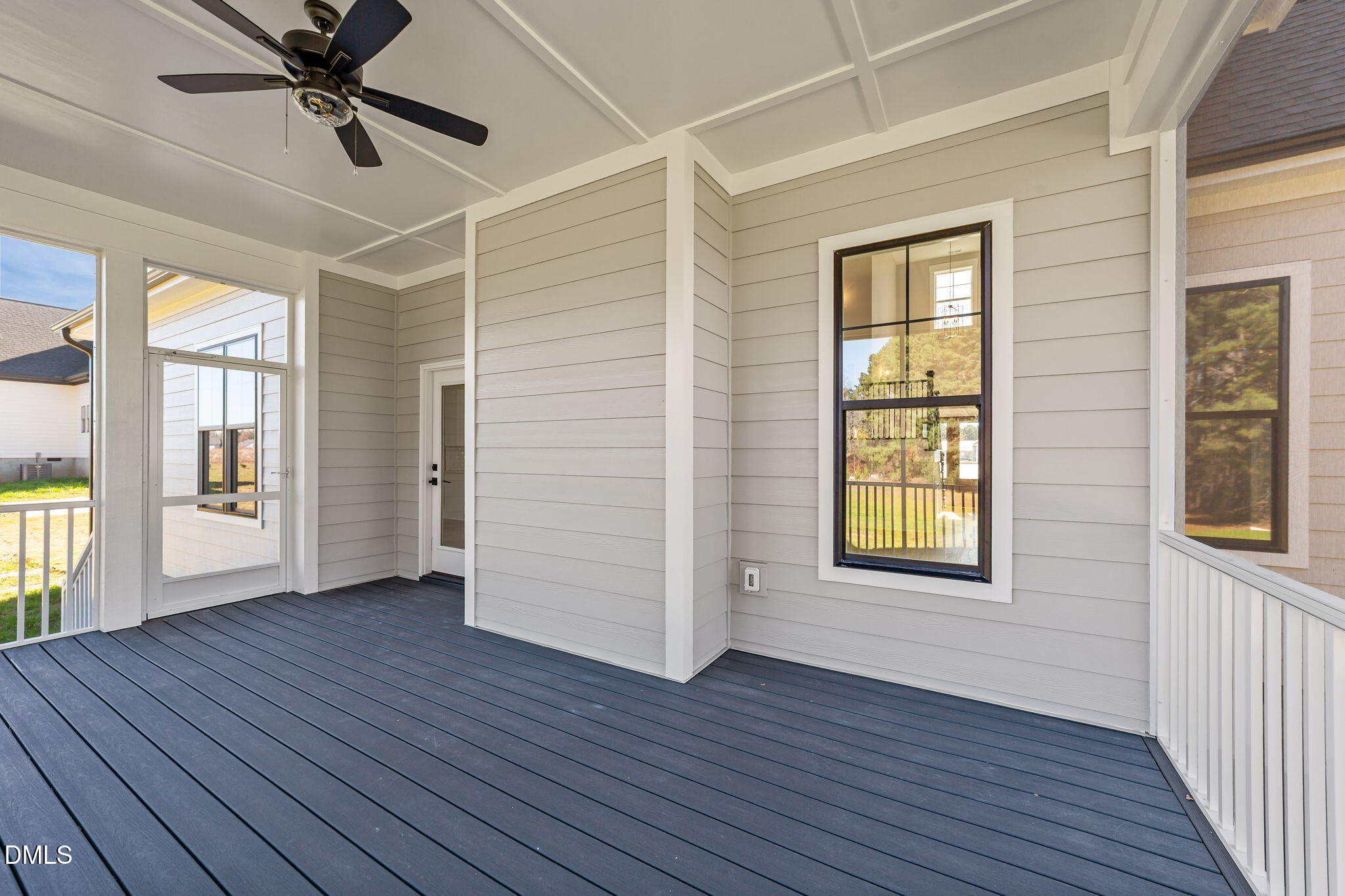 2568 Lassiter Road Four Oaks, NC 27524 - Photo 34 of 50 a view of an empty room with a window and wooden floor