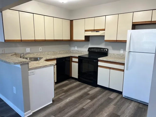 a kitchen with stainless steel appliances granite countertop a stove a sink dishwasher and a refrigerator