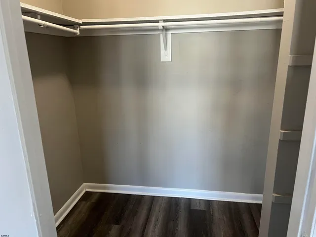 a view of a room with wooden floor and fan