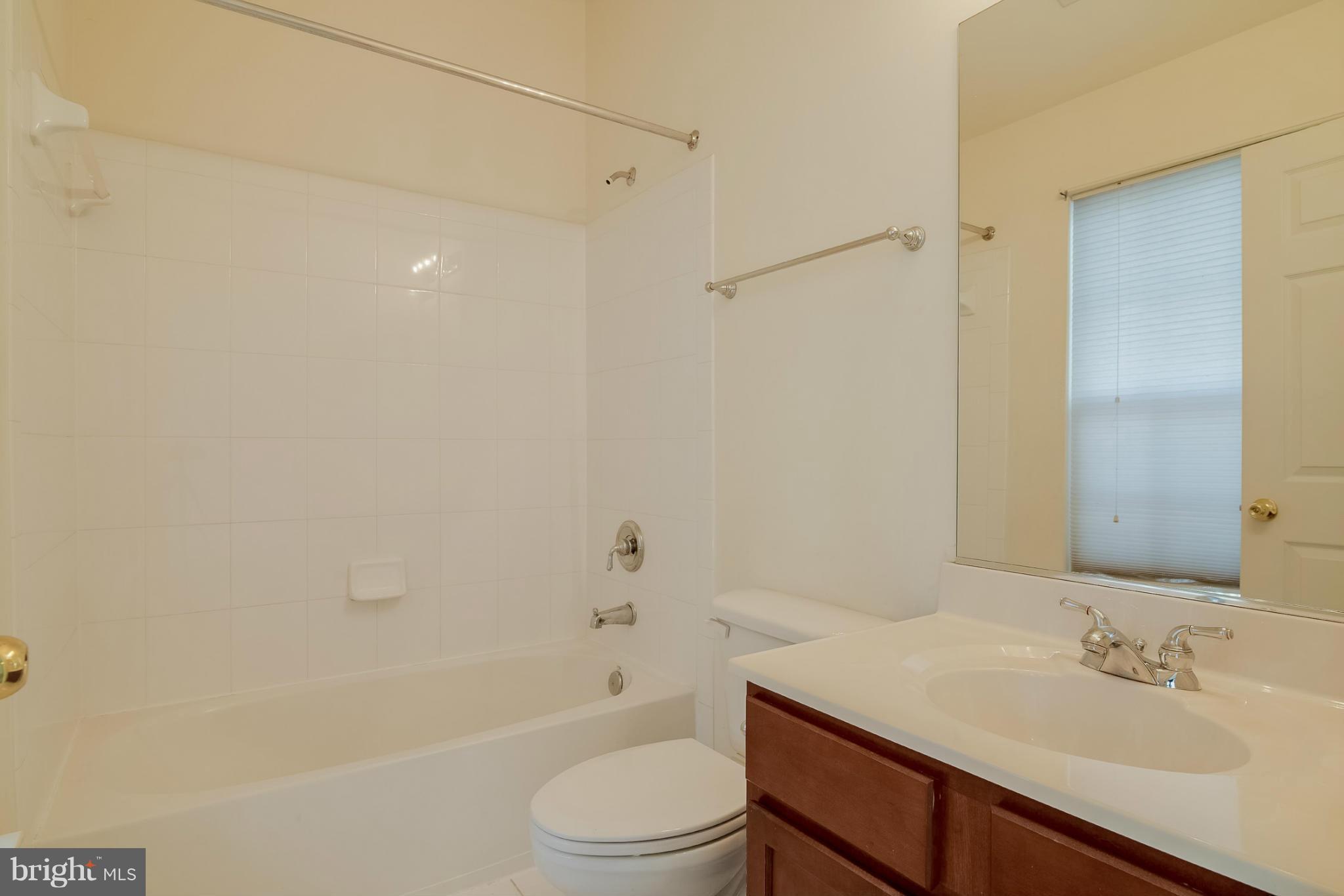 8103 Pennington Drive Laurel, MD 20724 - Photo 8 of 14 a bathroom with a sink a toilet and shower