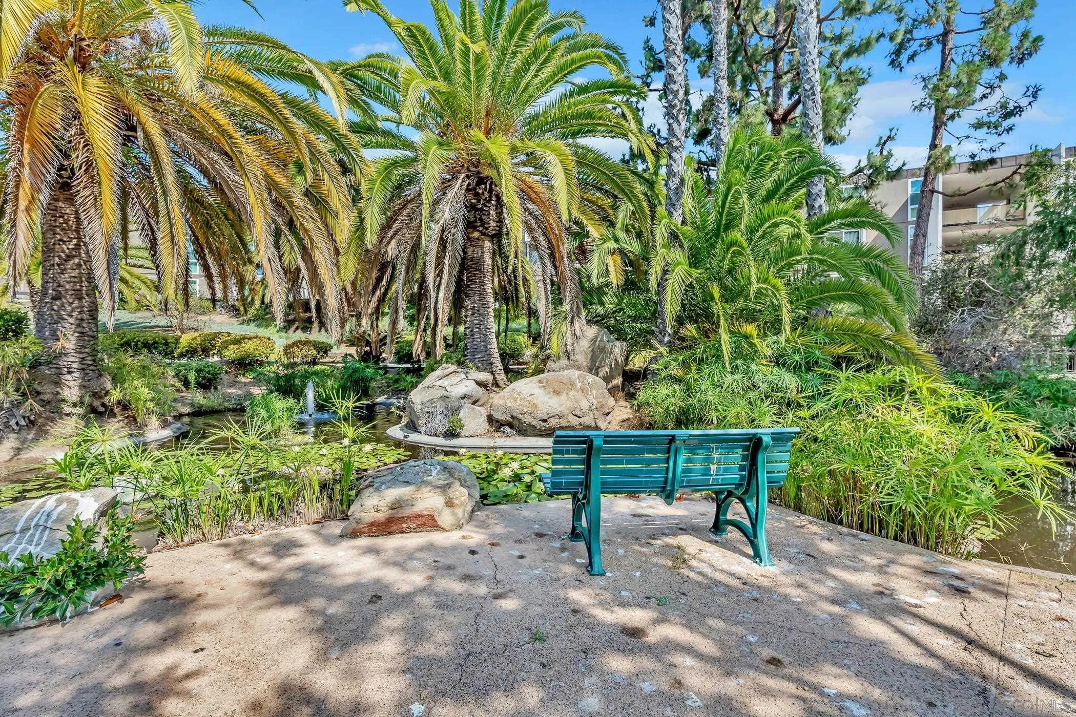 3050 Rue D’Orleans, Unit 461 San Diego, CA 92110 - Photo 13 of 23 a wooden bench sitting in a backyard of a house