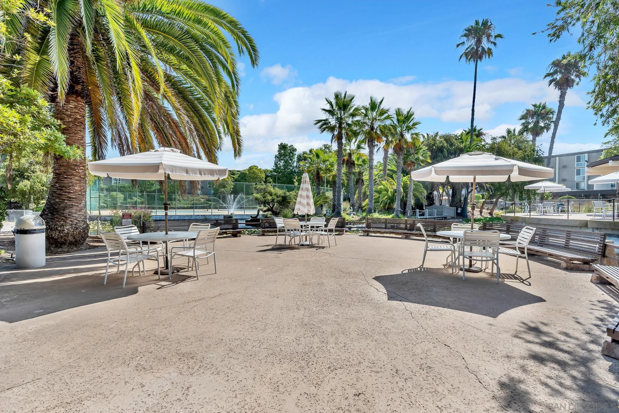 3050 Rue D’Orleans, Unit 461 San Diego, CA 92110 - Photo 20 of 23 a patio with a table and chairs under an umbrella