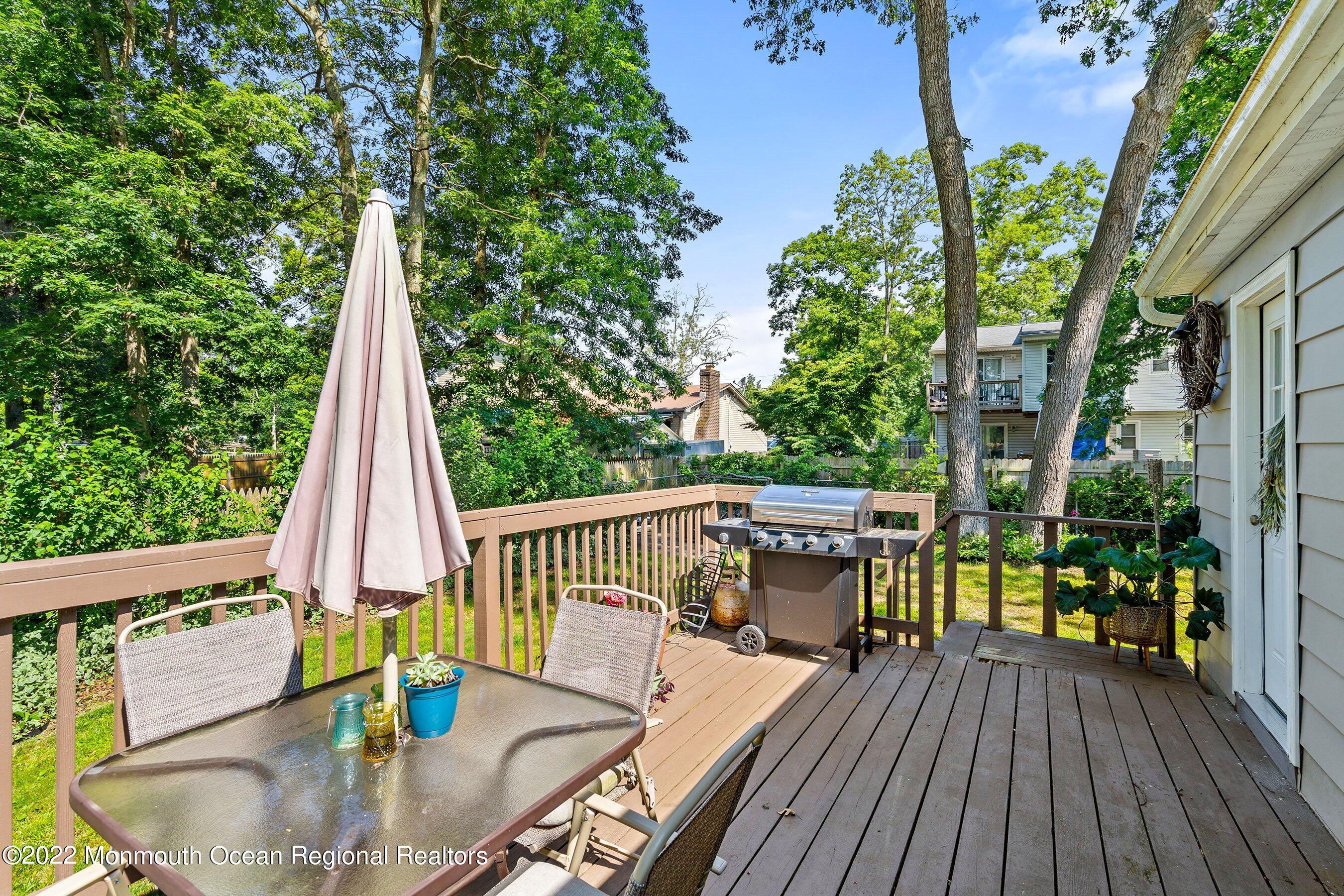 424 Eastern Boulevard Bayville, NJ 08721 - Photo 18 of 24 a balcony with wooden floor table and chairs