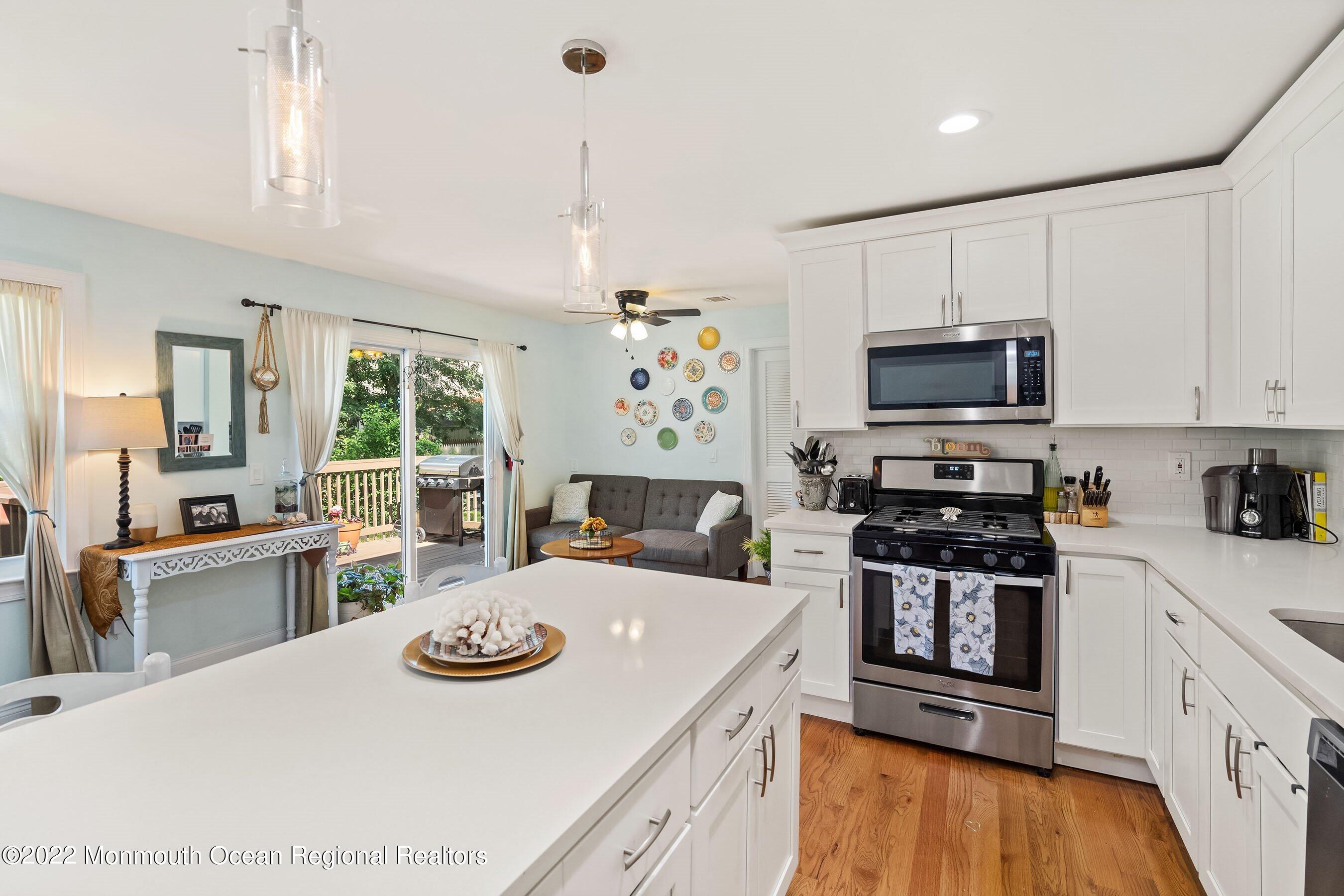 424 Eastern Boulevard Bayville, NJ 08721 - Photo 5 of 24 a kitchen with a stove a sink and a refrigerator