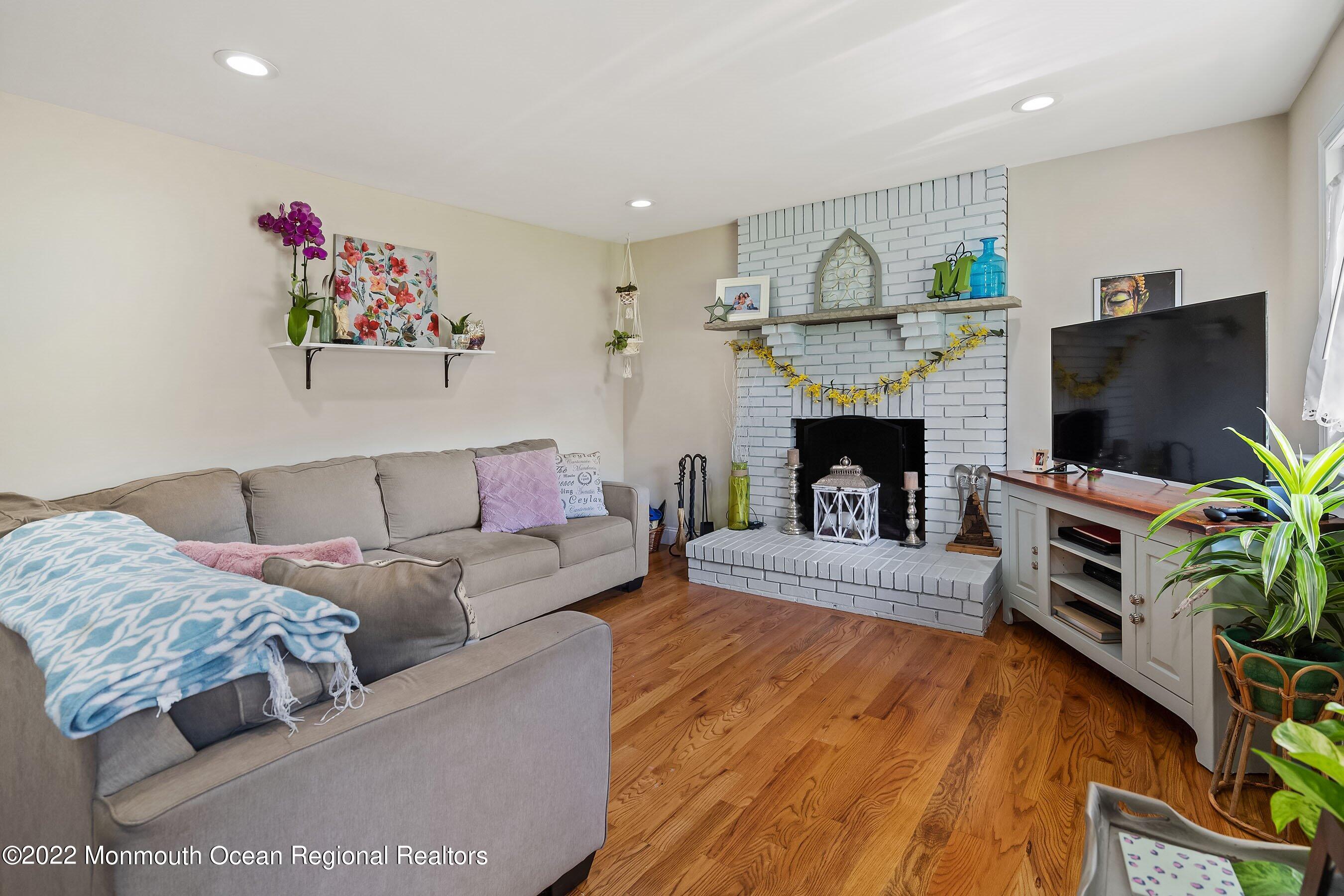 424 Eastern Boulevard Bayville, NJ 08721 - Photo 10 of 24 a living room with furniture and a fireplace