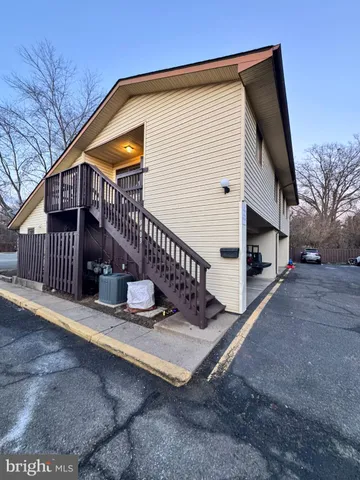 a view of a house with a yard next to a road