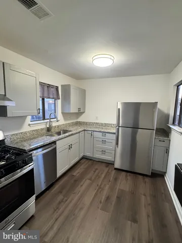 a kitchen with wooden cabinets and white appliances