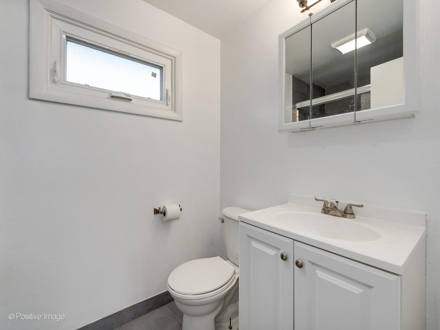 958 North Wheeling Road Mount Prospect, IL 60056 - Photo 12 of 17 a bathroom with a sink a toilet and mirror