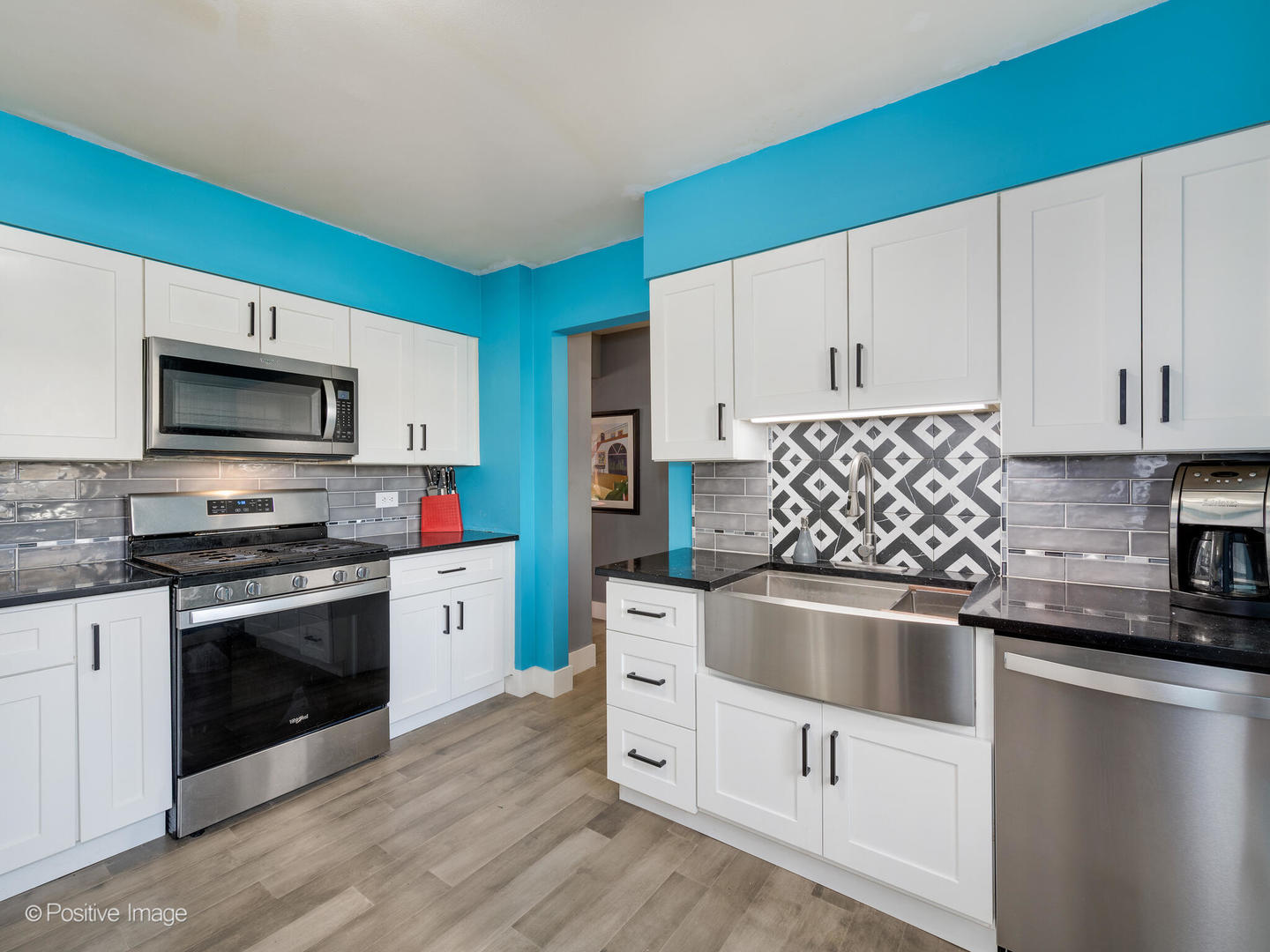 958 North Wheeling Road Mount Prospect, IL 60056 - Photo 7 of 17 a kitchen with white cabinets a sink dishwasher and a stove with wooden floor