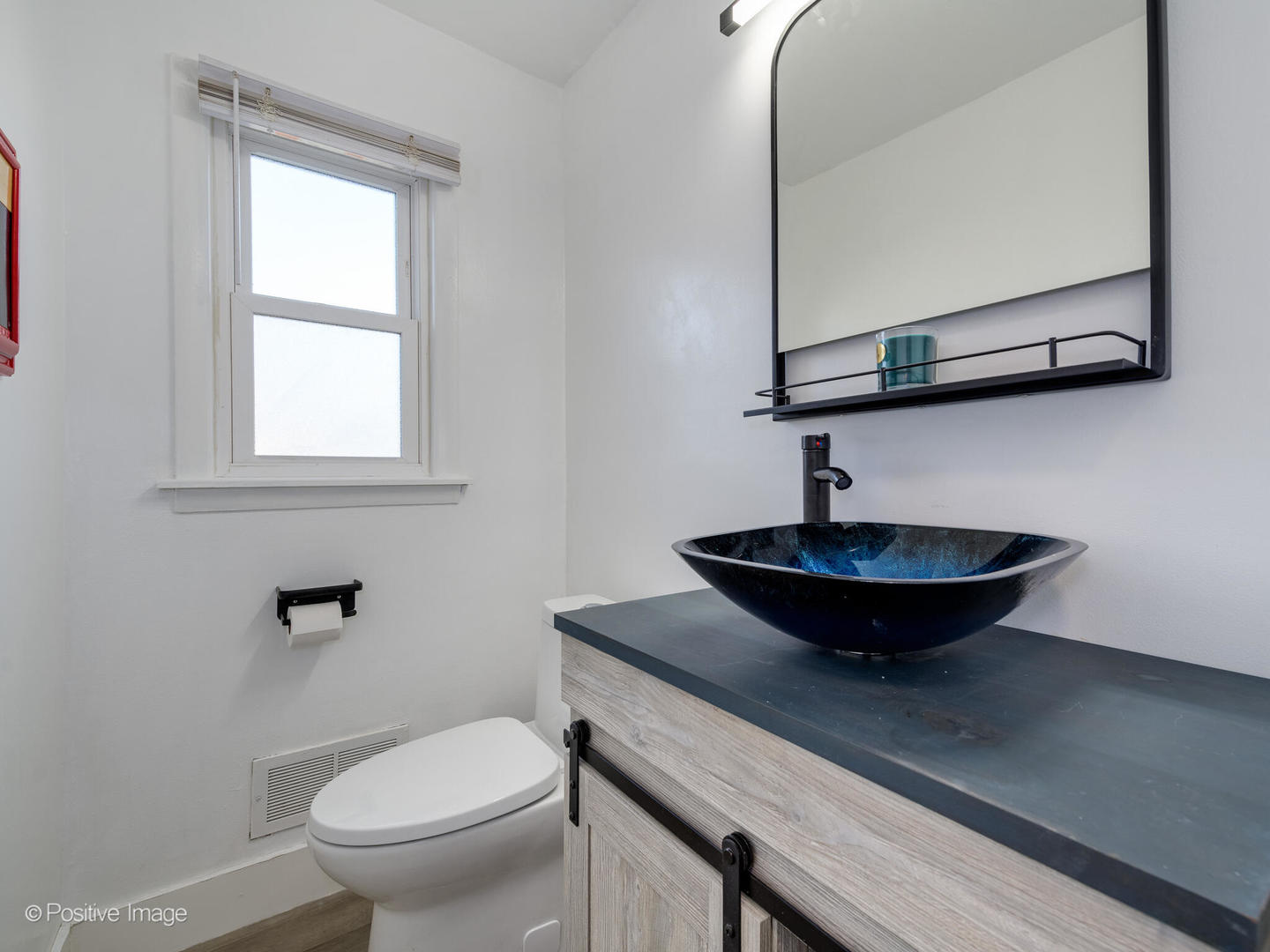 958 North Wheeling Road Mount Prospect, IL 60056 - Photo 8 of 17 a view of a bathroom with a sink and a mirror