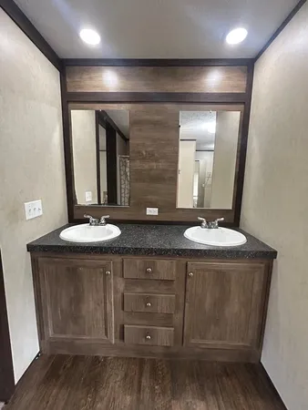 a bathroom with a double vanity sink and a mirror