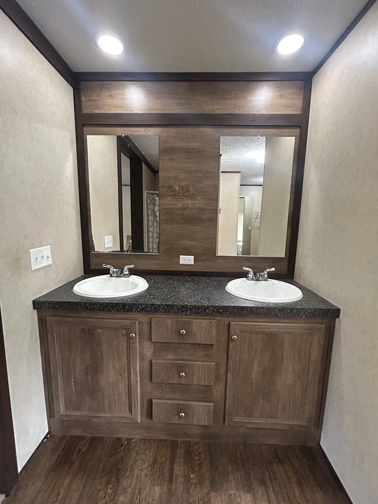 107 Oswichee Road Fort Mitchell, AL 36856 - Photo 11 of 56 a bathroom with a double vanity sink and a mirror
