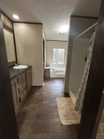 a view of walk in closet with wooden floor
