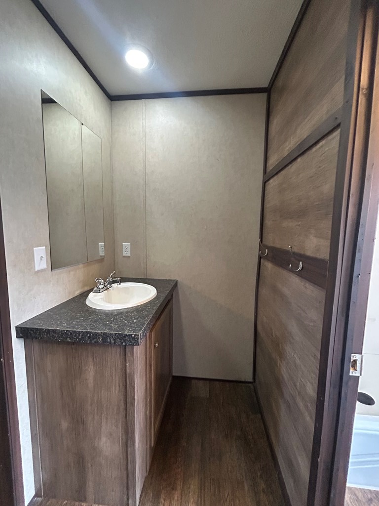 107 Oswichee Road Fort Mitchell, AL 36856 - Photo 26 of 56 a bathroom with a granite countertop sink and a mirror