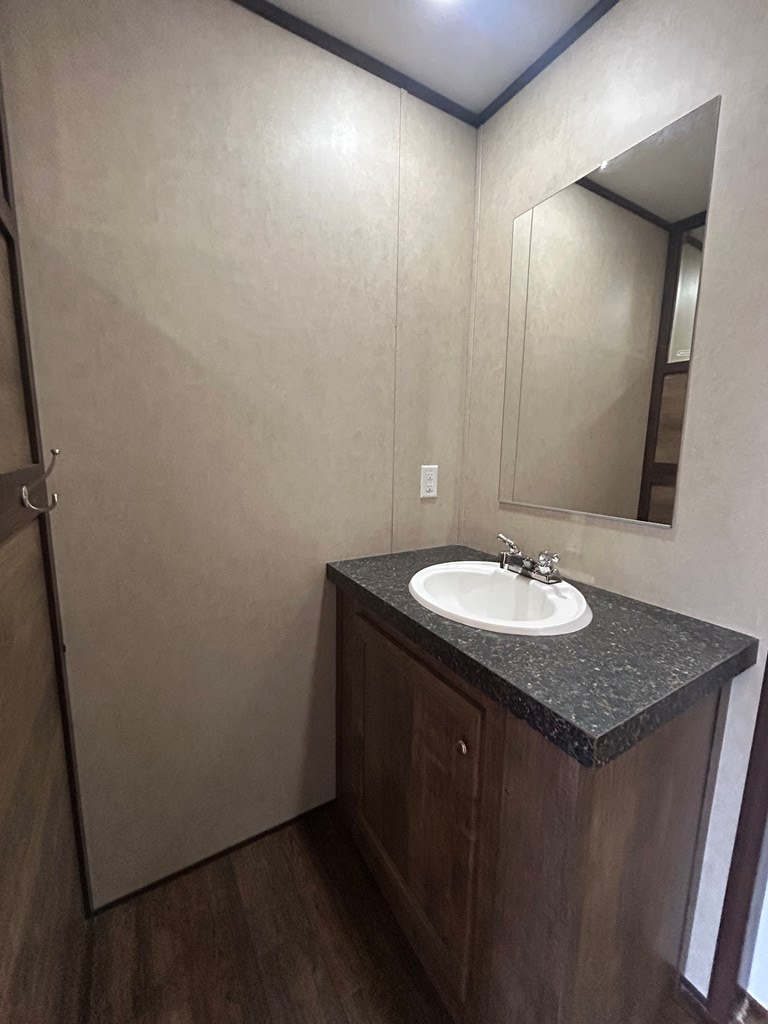 107 Oswichee Road Fort Mitchell, AL 36856 - Photo 27 of 56 a bathroom with a granite countertop sink and a mirror