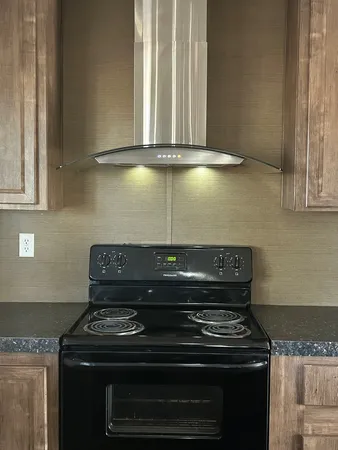 a stove top oven sitting inside of a kitchen