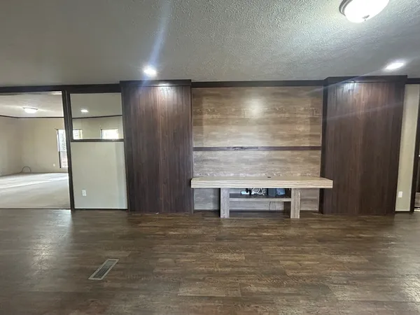 a kitchen with granite countertop a sink a stove and refrigerator