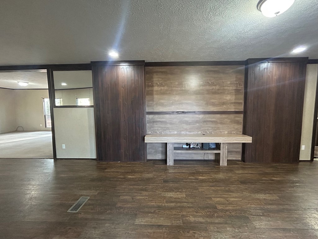 107 Oswichee Road Fort Mitchell, AL 36856 - Photo 34 of 56 a view of an empty room with wooden floor and a window