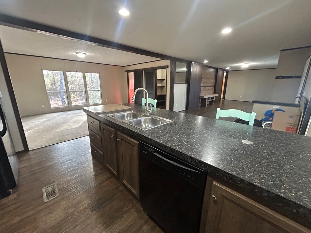 107 Oswichee Road Fort Mitchell, AL 36856 - Photo 36 of 56 a kitchen with stainless steel appliances granite countertop a sink a stove and a wooden floors