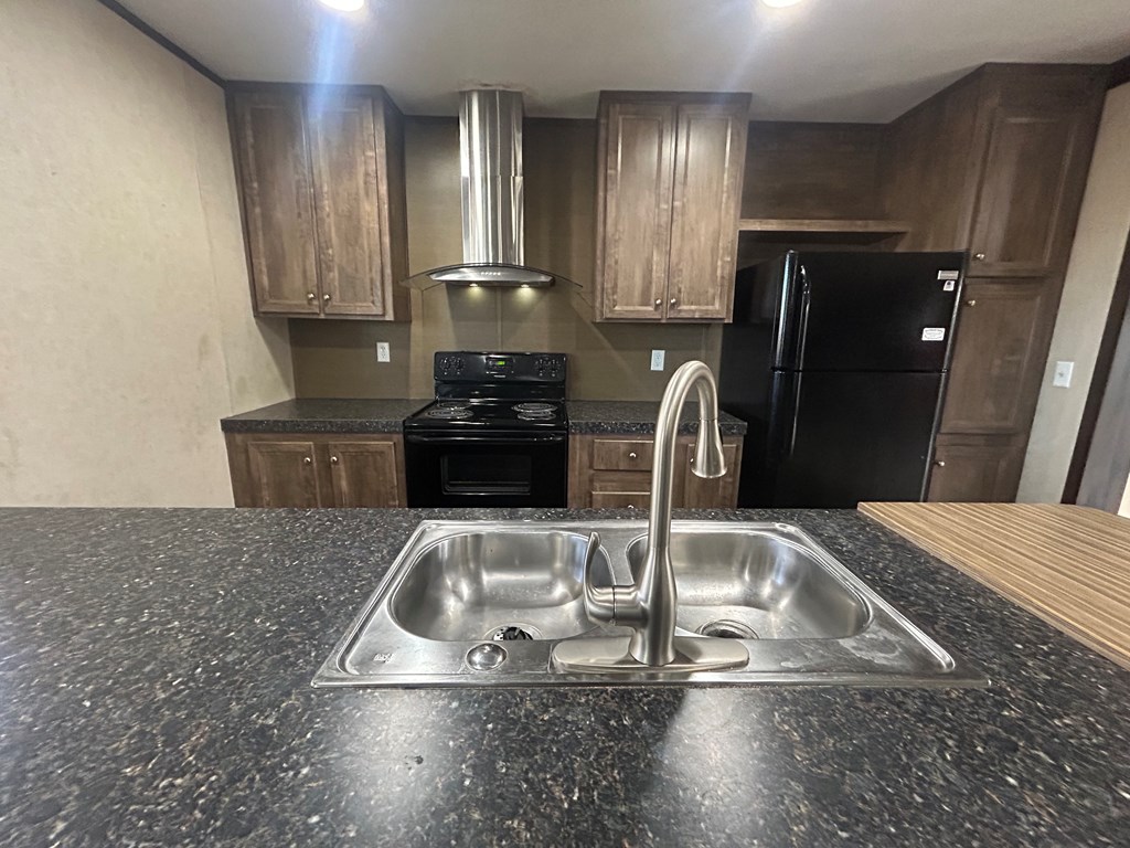 107 Oswichee Road Fort Mitchell, AL 36856 - Photo 38 of 56 a kitchen with granite countertop a sink a stove and refrigerator