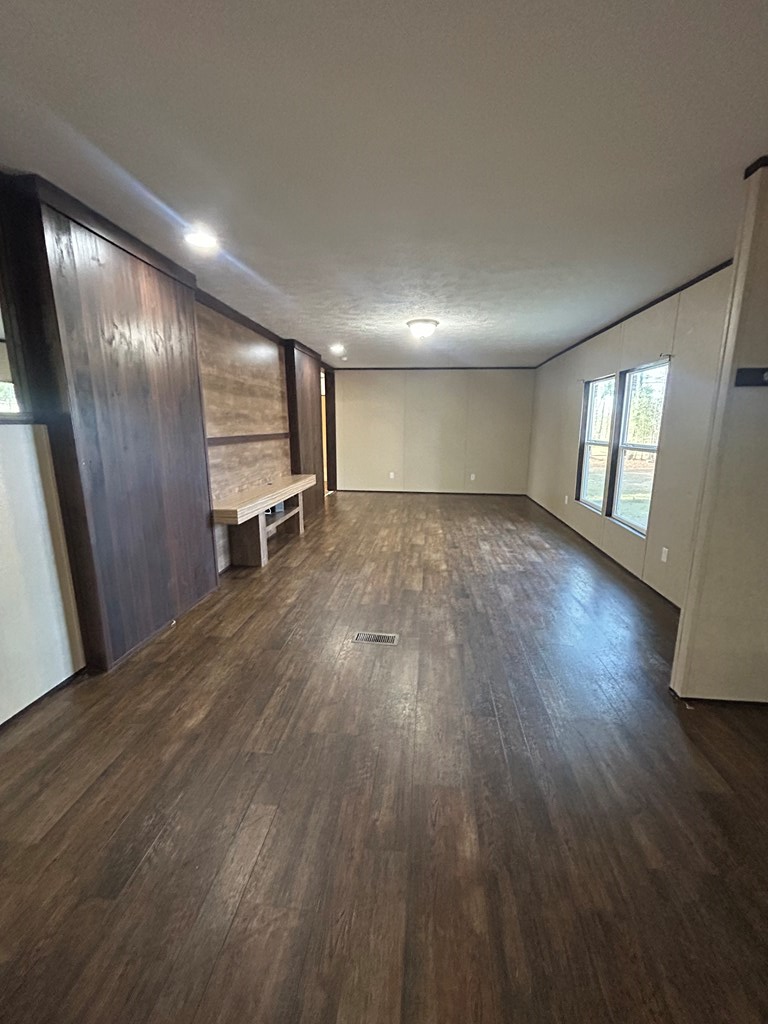 107 Oswichee Road Fort Mitchell, AL 36856 - Photo 39 of 56 an empty room with wooden floor and windows