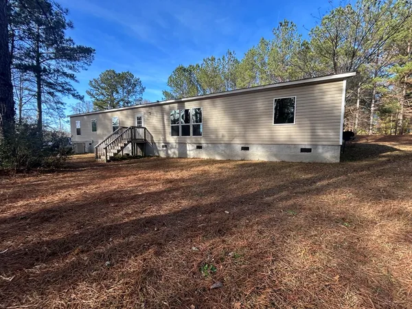 a view of a house with a yard and garage