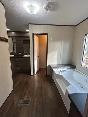 a living room with hard wood floors and furniture