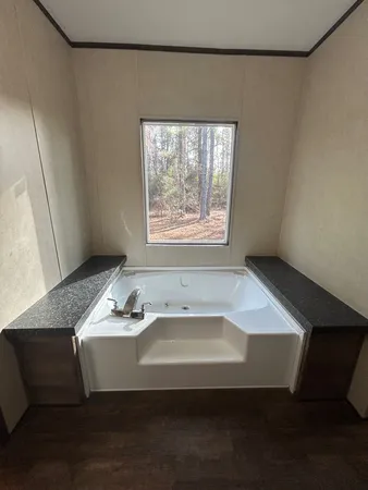 a bath tub sitting in a bathroom next to a window