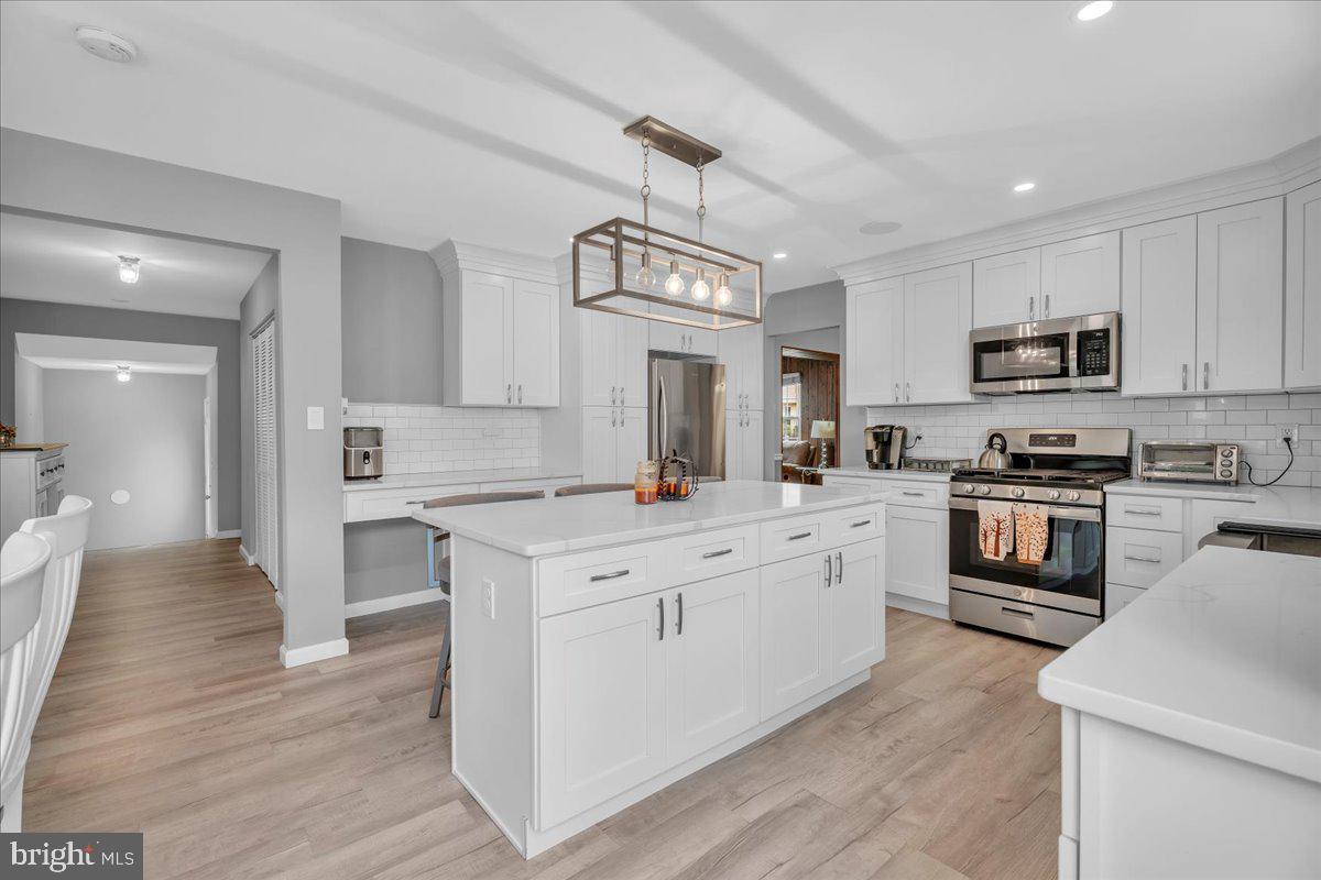 68 Sturbridge Drive Sicklerville, NJ 08081 - Photo 11 of 34 a large kitchen with cabinets wooden floor and stainless steel appliances