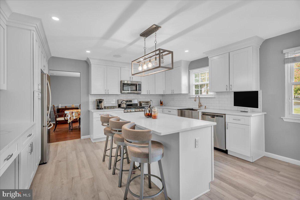 68 Sturbridge Drive Sicklerville, NJ 08081 - Photo 14 of 34 a kitchen with stainless steel appliances a stove a sink dishwasher a refrigerator white cabinets and wooden floor