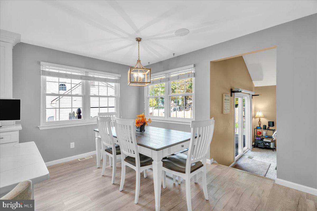 68 Sturbridge Drive Sicklerville, NJ 08081 - Photo 15 of 34 a dining room with furniture a chandelier and wooden floor