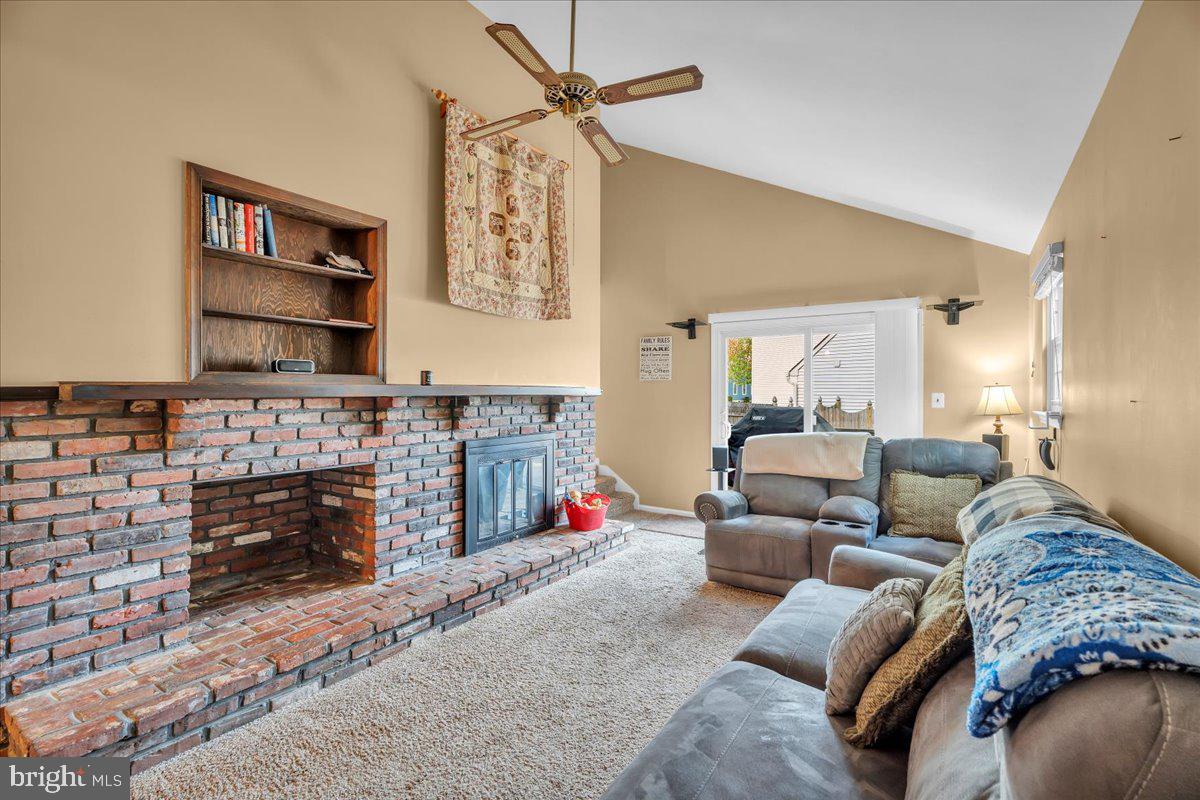 68 Sturbridge Drive Sicklerville, NJ 08081 - Photo 18 of 34 a living room with furniture a fireplace and a flat screen tv