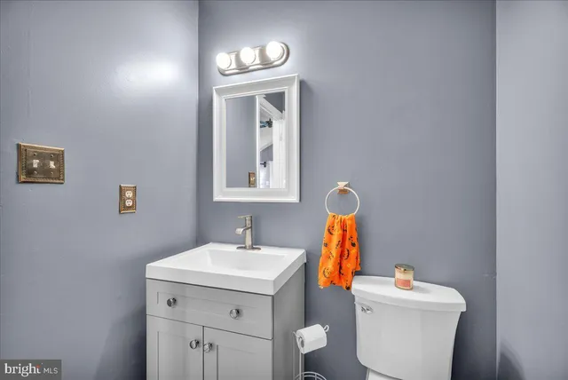 a bathroom with a toilet sink and mirror