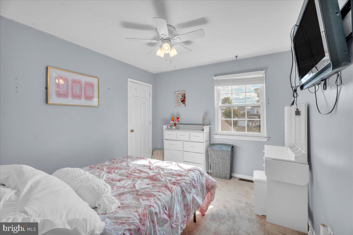 68 Sturbridge Drive Sicklerville, NJ 08081 - Photo 27 of 34 a bedroom with a large bed a flat tv screen and a chandelier