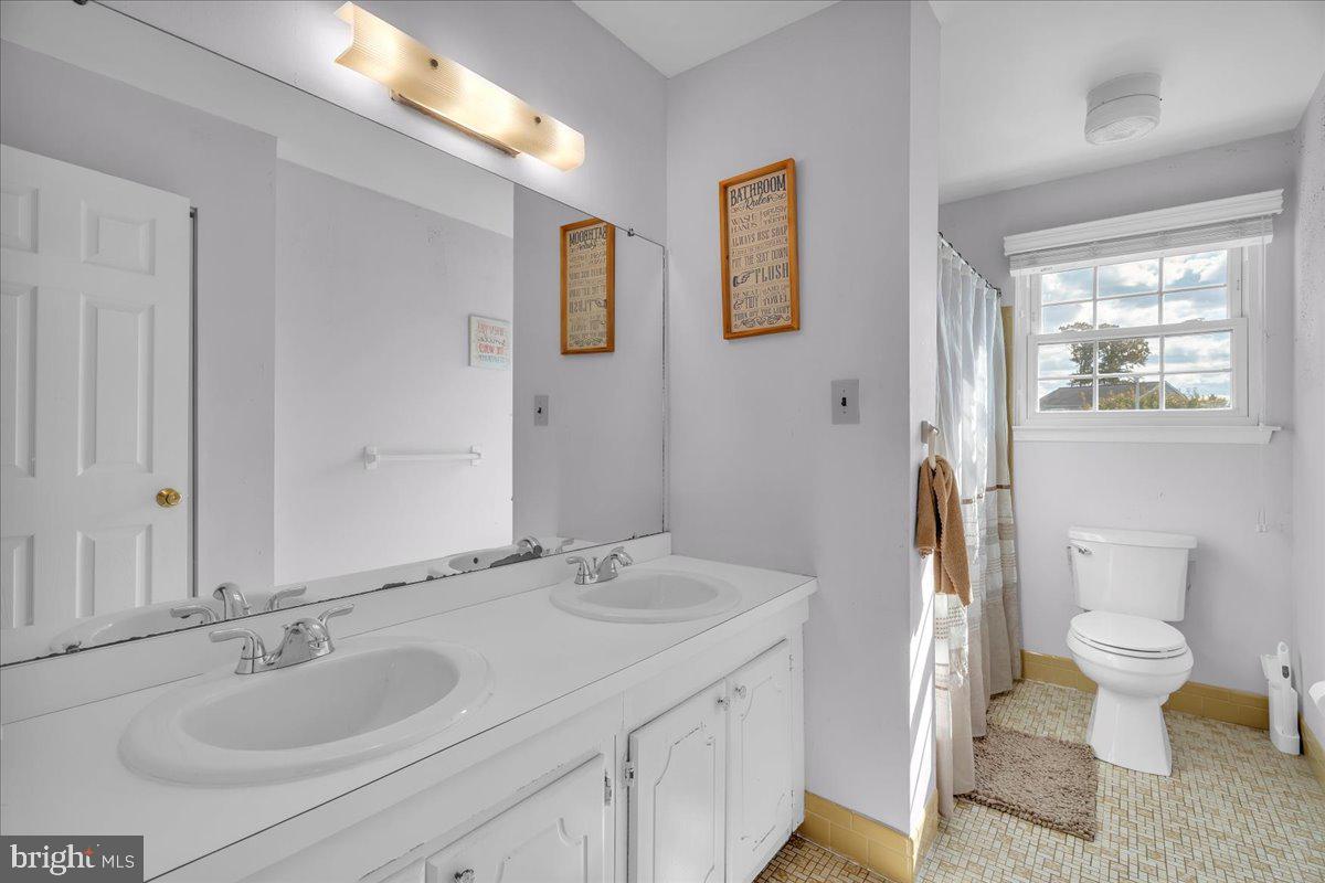 68 Sturbridge Drive Sicklerville, NJ 08081 - Photo 28 of 34 a bathroom with a granite countertop sink and a mirror