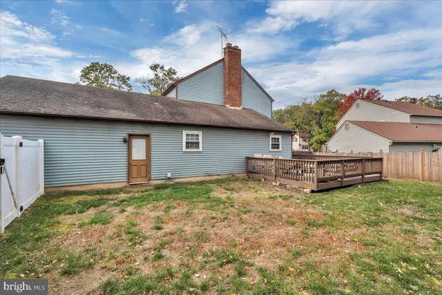 a view of a house with a yard and roof
